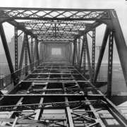 View of the partially constructed 23rd (Twenty-third) Street Viaduct over rail yards in the Five Points neighborhood of Denver, Colorado. Workmen are on the bridge in the distance.