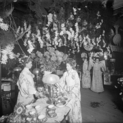 Interior view of the Daniels and Fisher store in Denver, Colorado; shows women in kimonos, chrysanthemums, and China tea service.
