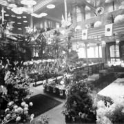 Interior view of the Daniels and Fisher store in Denver, Colorado; shows chrysanthemums, paper umbrellas, and Japanese flags.
