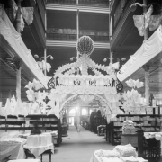 Interior view of the Daniels and Fisher store in Denver, Colorado; shows a display of fabric in the form of a gazebo, and the mezzanine.