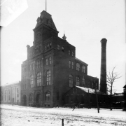 View of the Tivoli-Union Brewery at 10th and Larimer Streets in the Auraria neighborhood of Denver, Colorado. The four-story brick building has arched windows, decorative brick work, and a tower with a mansard roof.