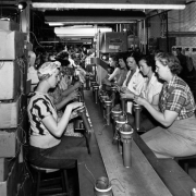 Women work on an assembly line at the Heckethorn Manufacturing Company in Littleton (Arapahoe County), Colorado. They work with metal cylinders with wires.