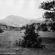 View of the Horace Ferguson Ranch in Estes Park, Larimer County, Colorado. Shows a ranch house, cabins and a barn.