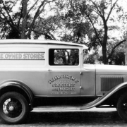 View of a delivery truck in Denver, Colorado; lettering reads: "Home Owned Stores," "Frank C. Thomas Quality Groceries and Market 2746 W. 26th Ave."