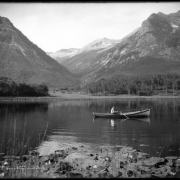 Partial view of Lily Lake near Marble, Colorado; shows lily pads and man fishing from row boat.