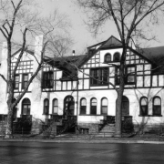 View of apartments in Denver, Colorado; features include arched windows and half timbering.
