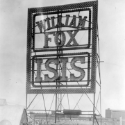View of an electric sign on the roof of the Isis Theater at 1722 Curtis Street in downtown Denver, Colorado. The sign reads: "William Fox Isis."