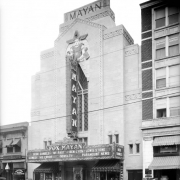 View of the Mayan Theater at 110 Broadway in the Speer neighborhood of Denver, Colorado. The four-story building has an ornate theater facade and a marquee that reads: "Bebe Daniels, 'My Past' and Ben Lyon Lewis Stone Comedy 'His Error' 'Novelty' Paramount News."