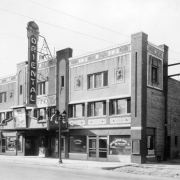 View of the Berkeley Oriental Theater at 44th (Forty-fourth) Avenue and Tennyson Street in the Berkeley neighborhood of Denver, Colorado. The three-story building has decorative trim and an electric sign that reads: "Oriental." Signs and lettering read: "Eggs," "Quality Market," "Oriental Barber Shop & Beauty Parlor," "William Boyd The Flying Fool," "Dr. S. C. Lutz "Dentist," and "Guy D. Lucas Coal Co. Direct from the Mines Sack Coal & Wood."