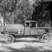View of an O'Malley-Kelley Oil and Auto Supply Company delivery truck in Denver, Colorado. Lettering on the side of the cab reads: "Zuni St & Lake Place."