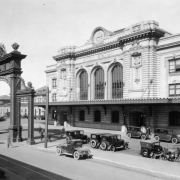 View of Union Station, in Denver, Colorado; also shows cars, the clock, and the Mizpah Arch.