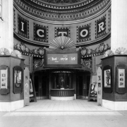 View of the Victory Theater in Denver, Colorado; shows the arched entry, ornate plaster, and signs: "D. W. Griffith's That Boyle Girl, A Paramount Picture."