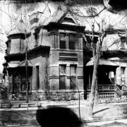 View of a house at 2601 Champa Street in the Five Points neighborhood of Denver, Colorado. The brick and stone Second Empire style house has a mansard roof, belt course, covered porch, and octagonal towers.