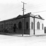 View of Epworth Church at 31st (Thirty-first) and Lawrence Streets in the Five Points neighborhood of Denver, Colorado. The brick church has arched windows decorated with tracery and decorative lintels. Lettering on an awning over the entryway reads: "Epworth Welcome."