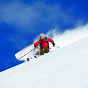 Ingrid Backstrom explores the pillars of ice and deep blue canyons of snow in the area around Blue River, British Columbia, Canada. From the film Higher Ground, by Warren Miller. 2005. Photo by Warren Miller Entertainment.