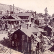 View of the Iron Silver Mine in Leadville, Lake County, Colorado. Shows Mine buildings, smokestacks and a trestle for ore cars.