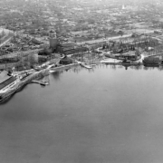 Aerial view of Lakeside Amusement Park in Lakeside (Jefferson County), Colorado. The roller coaster, ballroom, Casino Tower, casino, tea room and lake (Lake Rhoda) are shown.