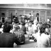 People's Fair, crowd seated watching musicans on stage