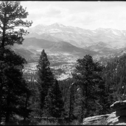 Distant view of Longs Peak (elevation 14,255 feet) and Mount Meeker (elevation 13,911 feet) from road above Estes Park, Colorado; backside of Stanley Hotel and distant view of Estes Park, center left; Rocky Mountains, Rocky Mountain National Park.