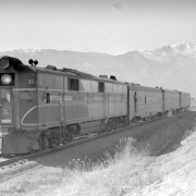 Train #8, Rocky Mountain Rocket; 3 cars, 35 MPH, shows Pikes Peak. Photographed: east of Colorado Springs, Colo., January 10, 1943.
