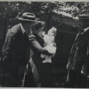 Men pose with a mother and her child, probably in Colorado.