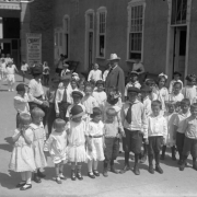 Children pose at Lakeside Amusement Park in Lakeside (Jefferson County), Colorado; adults are in the background.