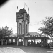View of the Lake Shore Railroad depot at Lakeside Amusement Park in Lakeside (Jefferson County), Colorado; a clock tower tops the arched entry.
