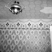 Interior detail of the original wallpaper in the Norman F. Meyer's residence Conifer, Jefferson County, Colorado; features geometric floral design; lantern light fixture, and areas of peeling or missing paper on the ceiling; house built for Louis Ramboz in 1889, on the same ranch that P. T. Barnum once wintered his elephants.