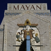 Detailed view of the top of the facade of the Mayan Theater (architect Montana S. Fallis, 1930) at 110 Broadway in the Speer neighborhood of Denver, Colorado. Shows a polychrome terracotta Mayan figure (crafted by Julius P. Ambrusch of the Denver Terra Cotta Company) on the front of the Art Deco-style theater. The facade was restored by architects Midyette-Seieroe, in 1985.