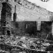 Only the stone chimney and fireplace remain at one of the cottages that burned during the fire of December 28, 1929, at the resort in  Eldorado Springs, Colorado.