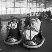 Women ride bumper cars at Lakeside Amusement Park in Lakeside (Jefferson County), Colorado; labels read: "Lusse Skooter."