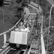 Men and women ride a roller coaster at Elitch Gardens in Denver, Colorado.