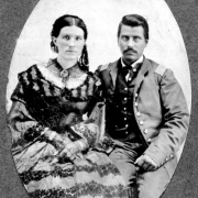 Studio portrait of Hispanic American Major Rafael Chacón and his wife Juanita Páiz de Chacón. Major Chacón served in the U.S. Army in New Mexico during the Civil War. He wears a uniform and has a mustache, his wife wears a long dress with a full skirt, decorated with cut velvet and lace. Her hair is parted in the middle and worn back in braids. After his retirement from the military, Major Chacón moved to Trinidad, Colorado, where he served as Las Animas County Treasurer and Sheriff.