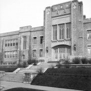 View of the Byers Junior High School entry and steps in the Speer neighborhood of Denver, Colorado; features leaded glass, tracery, and brick with stone and ceramic tile trim.