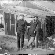 Outdoor portrait of teenaged boys with cigars by the Charles S. Lillybridge home in Denver, Colorado; sign reads: "Scenic Photographer."