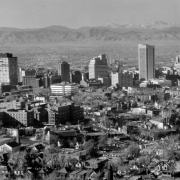 Aerial view of the skyline of the central business district of Denver, Colorado. Shows First National Bank Building, Continental Oil Company Building, Brown Palace Hotel, Mile High Center, Denver Club Building, Rocky Mountain Telephone Building, Denver Gas and Electric Building, Republic Building, and Scottish Rite Masonic Temple. The foothills of the Front Range are in the distance.