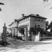 View of the J.K. Mullen Home for the Aged (later the Little Sisters of the Poor Mullen Home) at 3629 West 29th (Twenty-ninth) Avenue in the West Highland neighborhood of Denver, Colorado. Shows a neoclassical style four story building with a cupola and a formal gated entrance with a wrought iron fence.