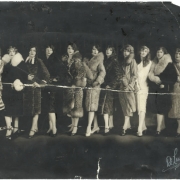 Women pose in outfits that include mink, fox, ermine, lynx, and ocelot fur coats, high heeled shoes, and marcel hair styles. Mickie Mackie (Shirly Copping) or Linay (?) Mackey is one of the group.