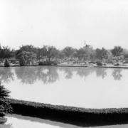 View of a Cherry Creek flood in Denver, Colorado after the Castlewood Canyon Dam break; shows an expanse of water and landscaping at the Sunken Gardens.