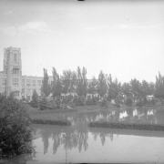 View of Cherry Creek floodwater in Denver, Colorado after the Castlewood Canyon Dam break; shows the Sunken Gardens under water and West High School.
