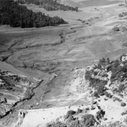 Aerial view of Cherry Creek and the destroyed Castlewood Dam in Douglas County, Colorado after the flood. Shows a farm house and barn.