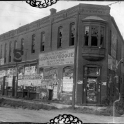 View of the former Douglas Hotel at 4050 Walnut Street in the Cole neighborhood of Denver, Colorado. Shows an abandoned building with broken windows and deteriorated paper advertisements for Barnes Circus and Jap Rose Soap. Sign painted on the side of the building reads: "Agents For This Property. Conway Bogue. Realty Inv. Co. Real Estate In All Branches. 524 17th St."