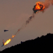 A PB4Y-2 slurry bomber plunges to the ground in flames.
