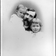 Studio, bust portrait of a man, a boy and a girl. Horace Swartley Poley has a moustache and wears a shirt with a starched, straight collar, and sits between his son and daughter. Frank Ferguson Poley wears a shirt with probably a rounded lace collar. Elizabeth Poley Schrader has bangs and wears a shirt with a ruffled, lace collar and a beaded necklace with a heart shaped charm or locket.