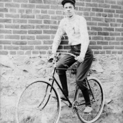 A teenaged boy poses on a bicycle in Denver, Colorado.