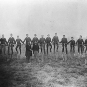 Men pose with high wheel bicycles in probably Denver, Colorado.