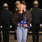 Brandi Stollak carries an American flag with Mike Stubbs.