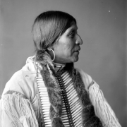 Profile studio portrait, head and shoulders, of Alvino Chavaria (aka Albino Chavarria), a Pueblo Native American man from Santa Clara, New Mexico; subject married Denver society woman Cora Arnold.