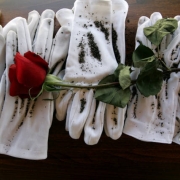 Sands of Iwo Jima cover white gloves at a Marine funeral.