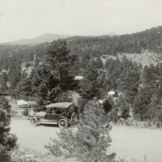 A car overlooks trees and tent cabins in Genesee Park (Denver Mountain Parks), in Jefferson County, Colorado.